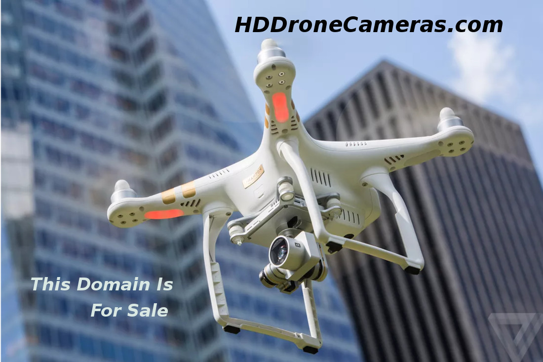 Dron equipped with camera near skyscrapers